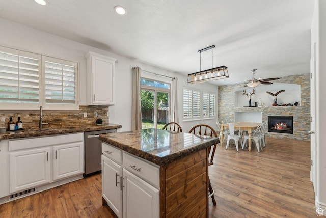15106 S Heather Stone Cir, Draper, UT 84020 - kitchen with stainless steel dishwasher, ceiling fan, decorative backsplash, white cabinets, and light wood-style floors