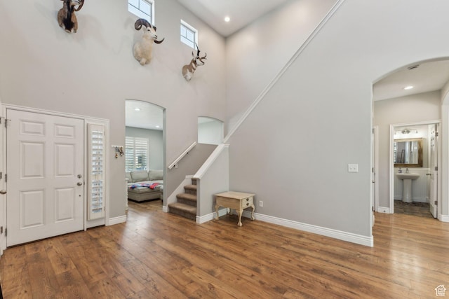 15106 S Heather Stone Cir, Draper, UT 84020 - entryway featuring arched walkways, hardwood / wood-style flooring, a high ceiling, stairs, and recessed lighting