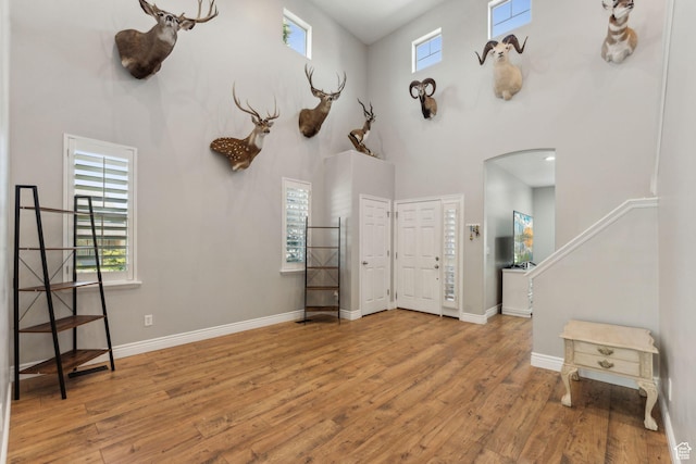 15106 S Heather Stone Cir, Draper, UT 84020 - entrance foyer featuring a towering ceiling, arched walkways, wood finished floors, and stairway