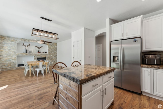 15106 S Heather Stone Cir, Draper, UT 84020 - kitchen featuring stainless steel fridge with ice dispenser, arched walkways, wood finished floors, and white cabinets