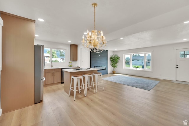 1003 E Platinum Way, Sandy, UT 84094 - kitchen with stainless steel appliances, light wood finished floors, open floor plan, recessed lighting, and a chandelier