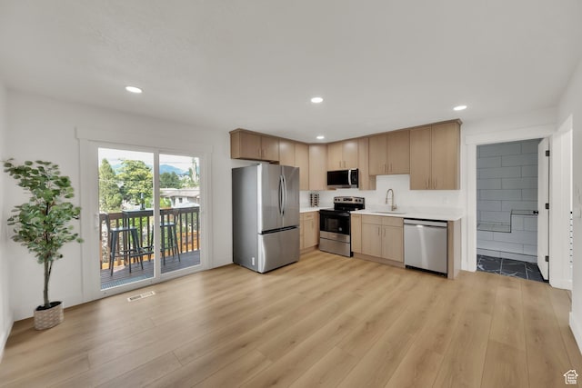 1003 E Platinum Way, Sandy, UT 84094 - kitchen featuring appliances with stainless steel finishes, light countertops, light wood-type flooring, recessed lighting, and light brown cabinetry