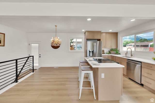 1003 E Platinum Way, Sandy, UT 84094 - kitchen featuring appliances with stainless steel finishes, light brown cabinetry, light wood-style floors, and recessed lighting