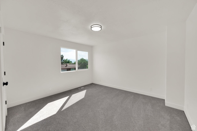 1003 E Platinum Way, Sandy, UT 84094 - spare room featuring dark carpet and baseboards