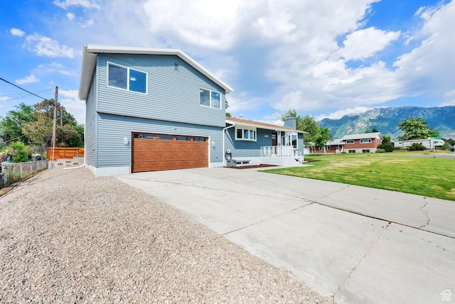 1003 E Platinum Way, Sandy, UT 84094 - view of front of property with a porch, a garage, driveway, and a mountain view