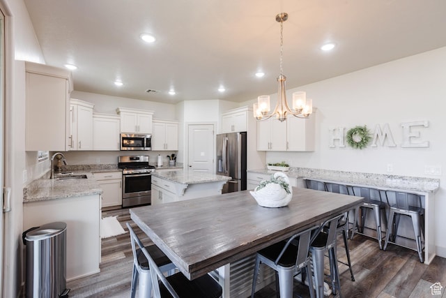 344 N Puerta Dr, Washington, UT 84780 - dining area featuring dark wood-style flooring, a chandelier, and recessed lighting