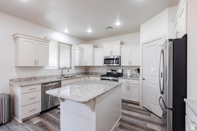 344 N Puerta Dr, Washington, UT 84780 - kitchen with appliances with stainless steel finishes, a kitchen island, dark wood-style floors, white cabinets, and recessed lighting
