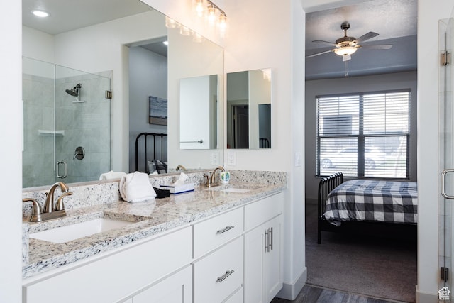 344 N Puerta Dr, Washington, UT 84780 - full bath with connected bathroom, double vanity, a shower stall, a ceiling fan, and wood finished floors