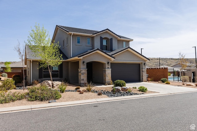 344 N Puerta Dr, Washington, UT 84780 - traditional home with stucco siding, concrete driveway, stone siding, and an attached garage