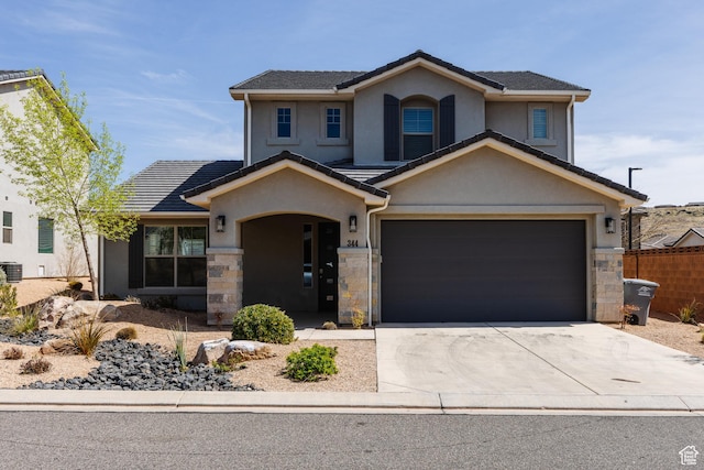 344 N Puerta Dr, Washington, UT 84780 - traditional-style house with stucco siding, concrete driveway, stone siding, an attached garage, and a tile roof