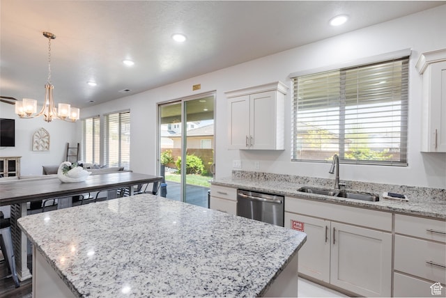 344 N Puerta Dr, Washington, UT 84780 - kitchen featuring stainless steel dishwasher, a chandelier, a kitchen island, light stone countertops, and white cabinetry