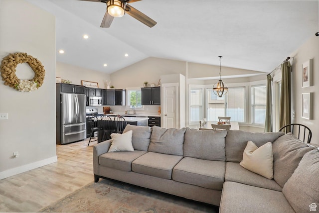 448 Lourdes Ln, Stansbury Park, UT 84074 - living room featuring vaulted ceiling, light wood-style floors, ceiling fan, and recessed lighting