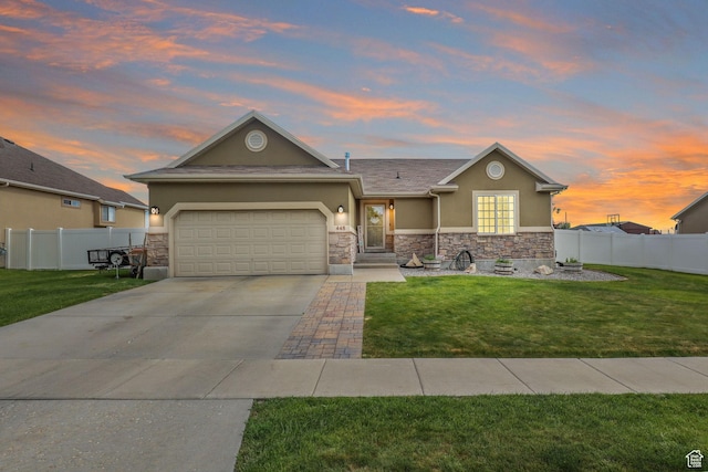 448 Lourdes Ln, Stansbury Park, UT 84074 - view of front of home with stucco siding, stone siding, a garage, and driveway