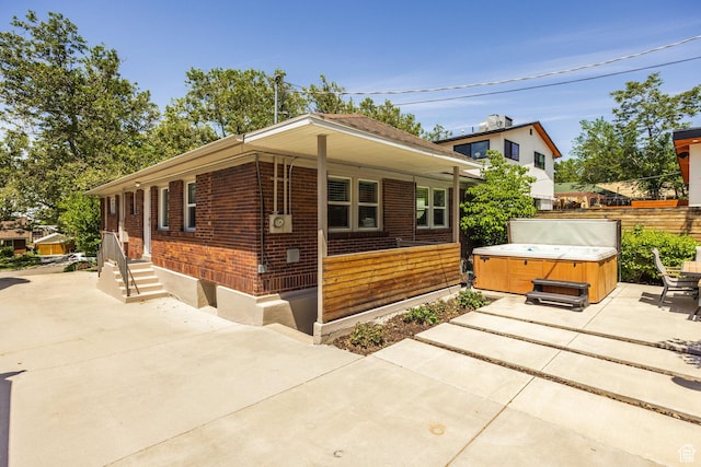 1603 S 1600 E, Salt Lake City, UT 84105 - view of front of home featuring a hot tub, brick siding, and a patio area