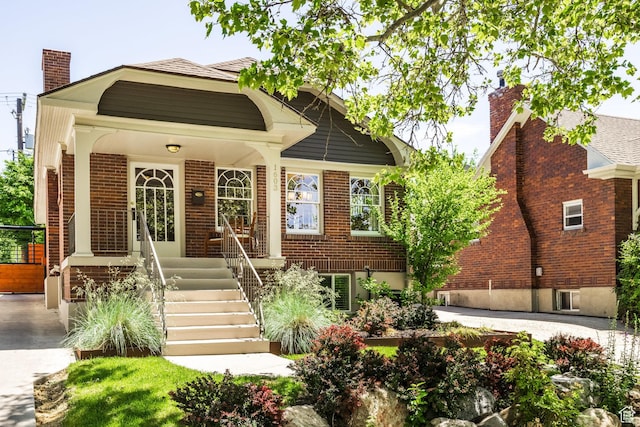 1603 S 1600 E, Salt Lake City, UT 84105 - view of front of house featuring a chimney, brick siding, and covered porch