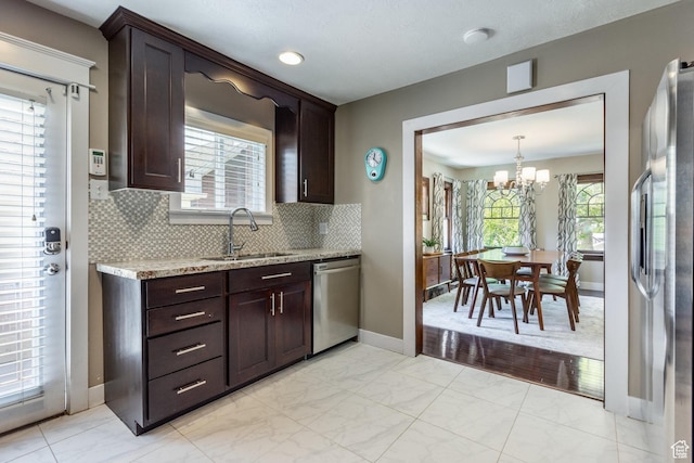 1603 S 1600 E, Salt Lake City, UT 84105 - kitchen featuring appliances with stainless steel finishes, a chandelier, and dark brown cabinets