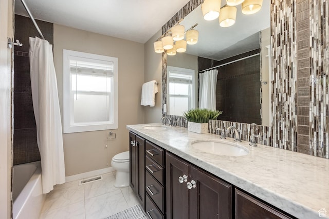 1603 S 1600 E, Salt Lake City, UT 84105 - full bath featuring double vanity, shower / bathtub combination with curtain, and marble look tiles