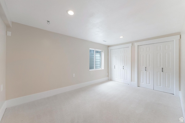 8743 N Franklin Dr E, Eagle Mountain, UT 84005 - unfurnished bedroom featuring two closets, carpet, and recessed lighting