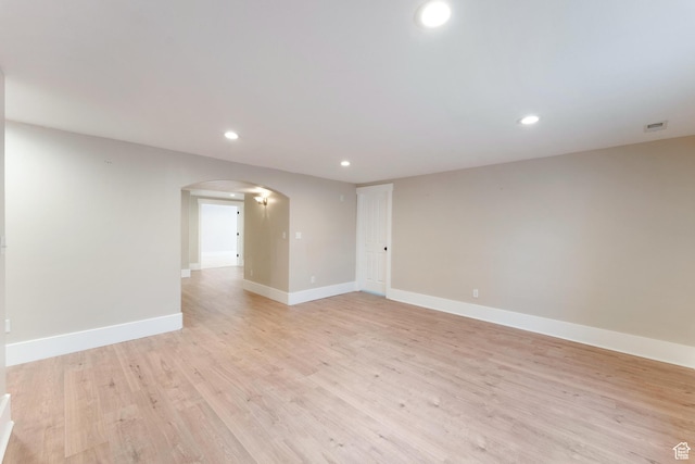 8743 N Franklin Dr E, Eagle Mountain, UT 84005 - spare room with arched walkways, recessed lighting, and light wood finished floors