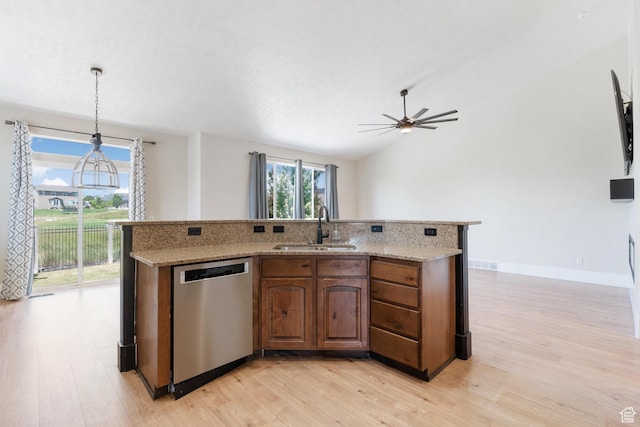 8743 N Franklin Dr E, Eagle Mountain, UT 84005 - kitchen with stainless steel dishwasher, light wood finished floors, a ceiling fan, light stone countertops, and lofted ceiling