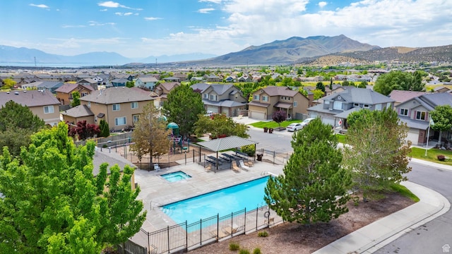 8743 N Franklin Dr E, Eagle Mountain, UT 84005 - aerial view of residential area featuring a mountain backdrop and a pool area