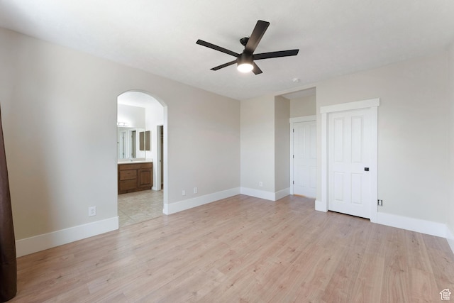 8743 N Franklin Dr E, Eagle Mountain, UT 84005 - unfurnished room with arched walkways, a ceiling fan, and light wood-style floors