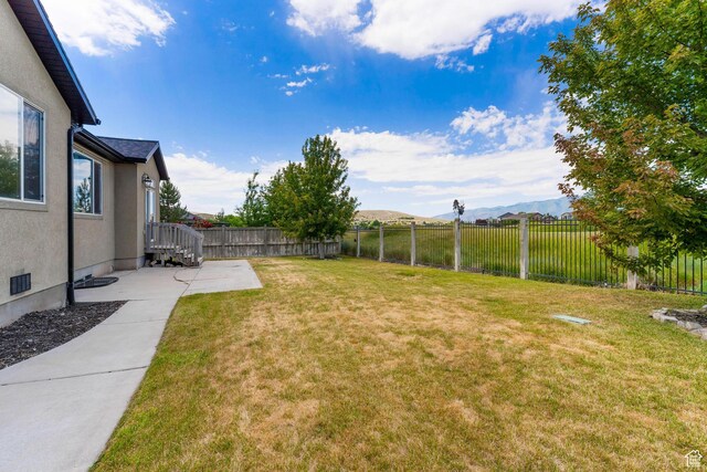 8743 N Franklin Dr E, Eagle Mountain, UT 84005 - fenced yard with a mountain view and a patio area