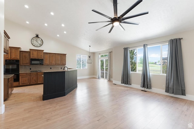 8743 N Franklin Dr E, Eagle Mountain, UT 84005 - kitchen with black appliances, ceiling fan, brown cabinetry, light wood finished floors, and recessed lighting