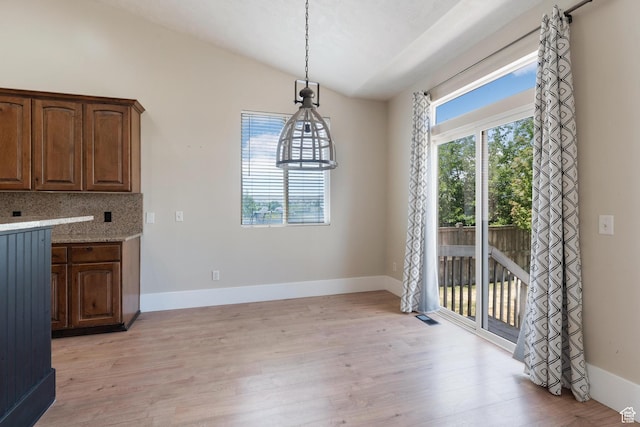 8743 N Franklin Dr E, Eagle Mountain, UT 84005 - unfurnished dining area with vaulted ceiling and light wood-type flooring
