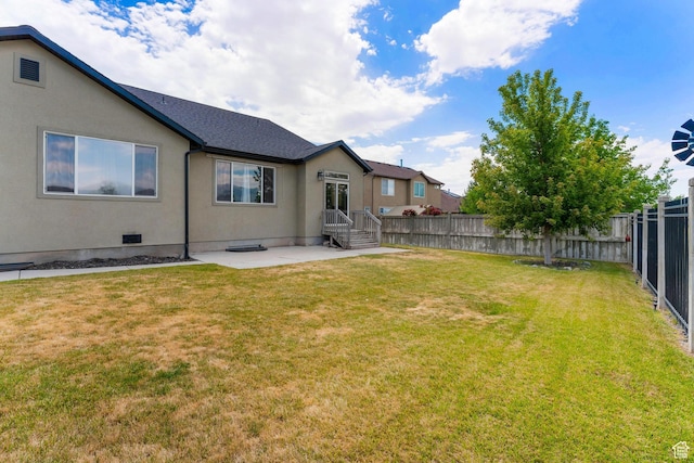 8743 N Franklin Dr E, Eagle Mountain, UT 84005 - back of house with a fenced backyard, a patio area, and stucco siding