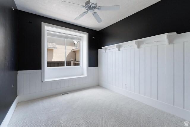 8743 N Franklin Dr E, Eagle Mountain, UT 84005 - carpeted spare room featuring wainscoting and a ceiling fan