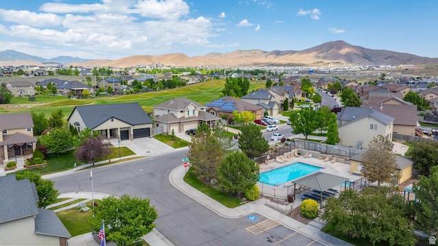 8743 N Franklin Dr E, Eagle Mountain, UT 84005 - aerial view of residential area featuring a mountainous background and a pool