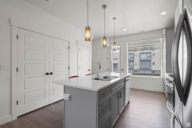 11079 S Lake Run Rd, South Jordan, UT 84009 - kitchen with gray cabinets, light countertops, an island with sink, wood finished floors, and stainless steel appliances