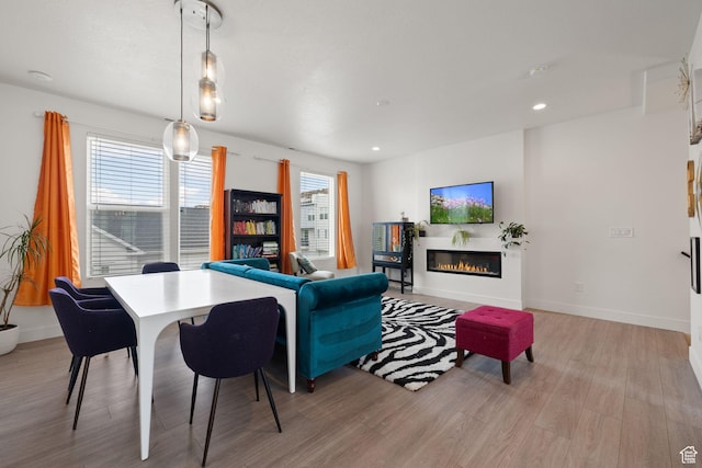 11079 S Lake Run Rd, South Jordan, UT 84009 - living room featuring light wood-style floors, a glass covered fireplace, and recessed lighting
