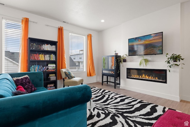11079 S Lake Run Rd, South Jordan, UT 84009 - living area with wood finished floors, a glass covered fireplace, and recessed lighting