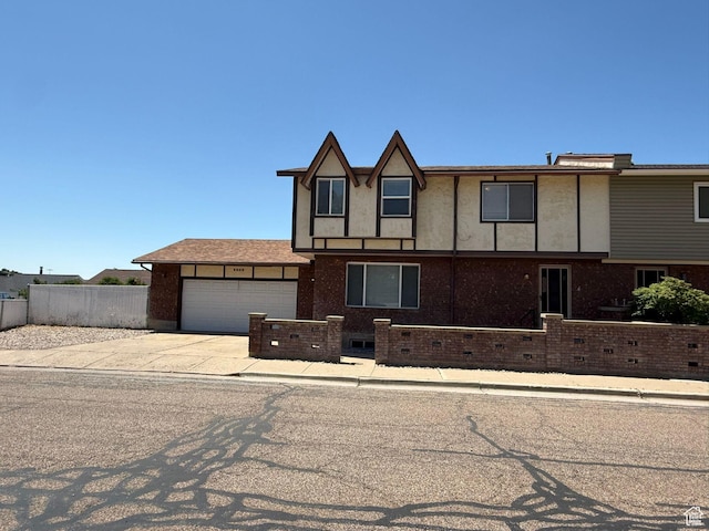 5509 S 2150 W, Roy, UT 84067 - view of front of house with an attached garage, driveway, and brick siding