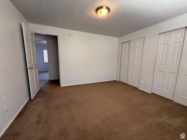 5509 S 2150 W, Roy, UT 84067 - unfurnished bedroom with carpet flooring, multiple closets, and a textured ceiling