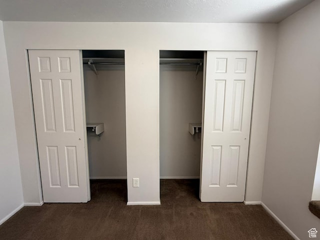 5509 S 2150 W, Roy, UT 84067 - unfurnished bedroom featuring dark colored carpet and two closets