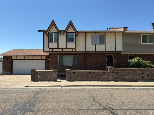 5509 S 2150 W, Roy, UT 84067 - view of front of home featuring an attached garage, driveway, and brick siding