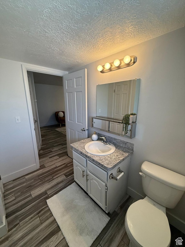 5509 S 2150 W, Roy, UT 84067 - half bathroom featuring wood finished floors, vanity, and a textured ceiling