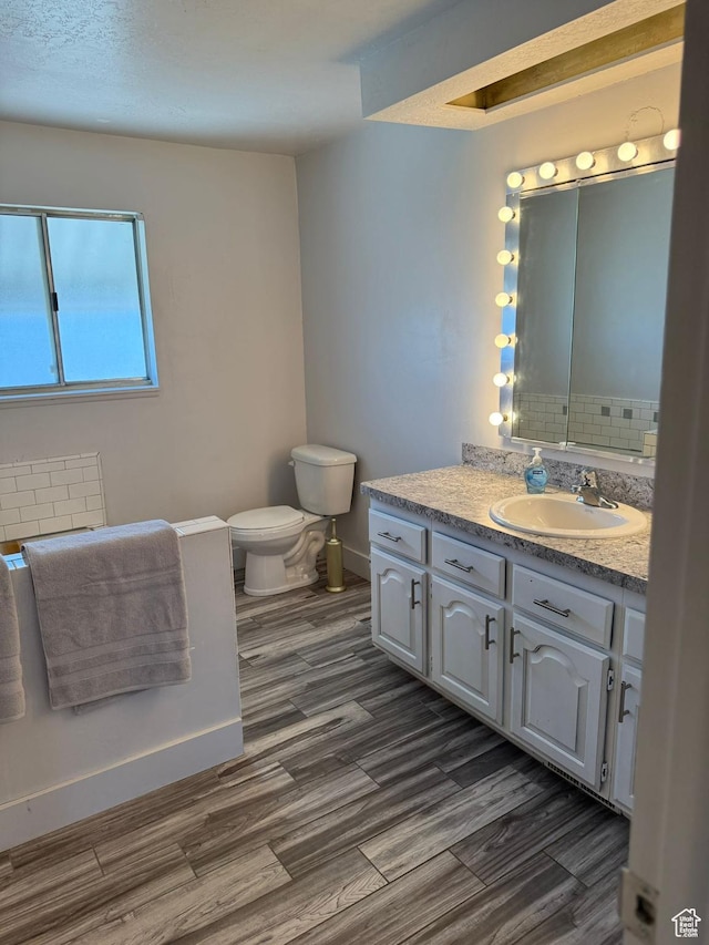 5509 S 2150 W, Roy, UT 84067 - bathroom with vanity, wood finished floors, and decorative backsplash