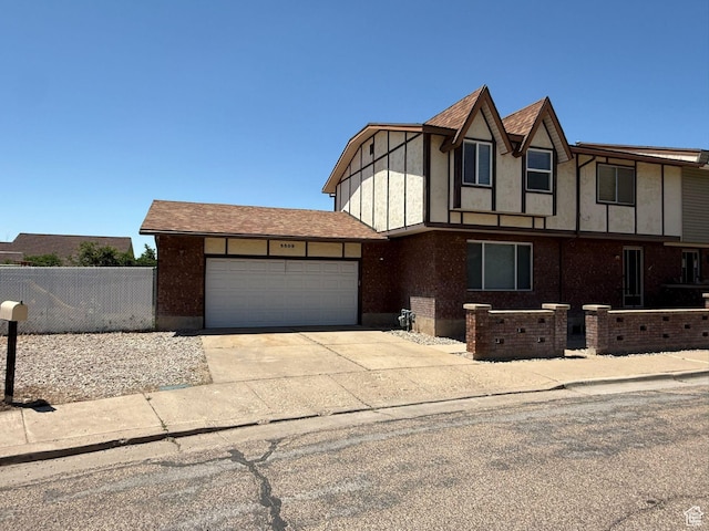 5509 S 2150 W, Roy, UT 84067 - tudor home with an attached garage and concrete driveway