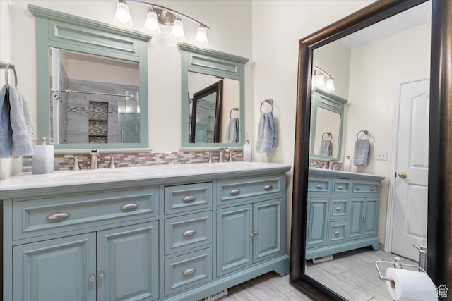 231 S 200 E, Manti, UT 84642 - bathroom with double vanity, a stall shower, and decorative backsplash