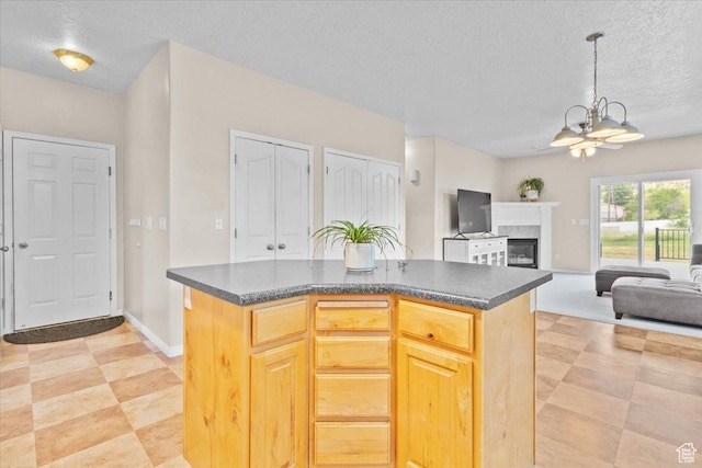 231 S 200 E, Manti, UT 84642 - kitchen featuring dark countertops, a textured ceiling, a chandelier, hanging light fixtures, and a center island