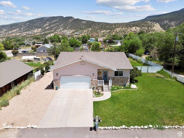 231 S 200 E, Manti, UT 84642 - view of front of home with stone siding, a garage, driveway, and a mountain view