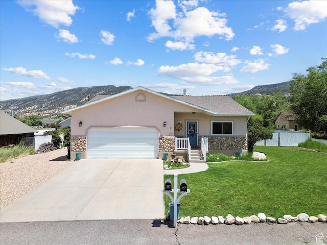 231 S 200 E, Manti, UT 84642 - view of front facade featuring stone siding, stucco siding, a mountain view, and a garage