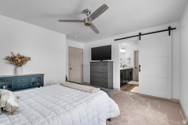 106 E Polaris Dr, Saratoga Springs, UT 84045 - bedroom with a barn door, carpet flooring, ensuite bath, and ceiling fan