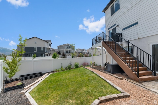 106 E Polaris Dr, Saratoga Springs, UT 84045 - fenced backyard featuring a residential view, stairs, and a vegetable garden
