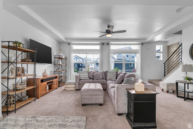 106 E Polaris Dr, Saratoga Springs, UT 84045 - living room featuring light colored carpet, plenty of natural light, a ceiling fan, stairs, and a textured ceiling