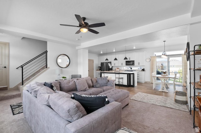 106 E Polaris Dr, Saratoga Springs, UT 84045 - living room with light colored carpet, a ceiling fan, and stairway